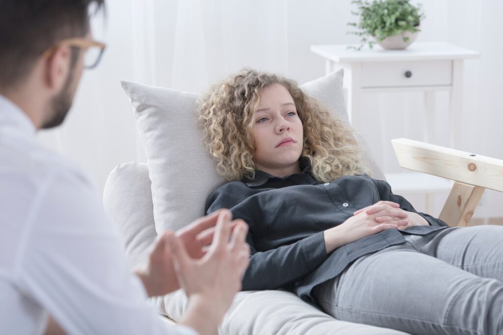 Patient lying on therapy sofa